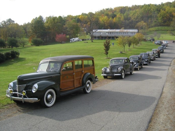 Antique cars with a lodge on the hill